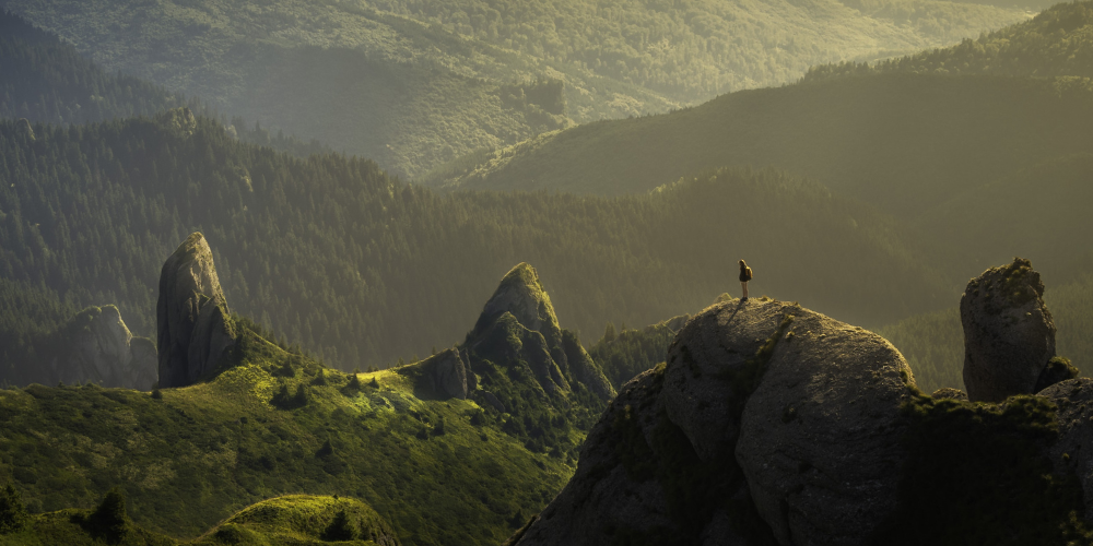Group of friends embracing the outdoors at sunset, ready for an adventure in the mountains.