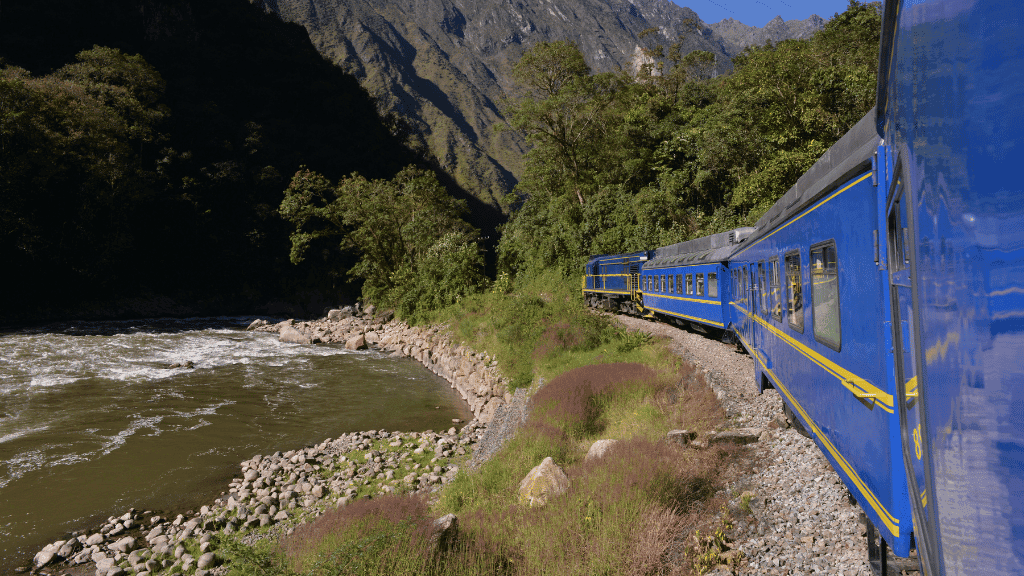 Blue PeruRail train winding through Sacred Valley on Peru Adventure - Machu Picchu 14 Days | Small-Group Travel. Scenic rail journey to Machu Picchu.