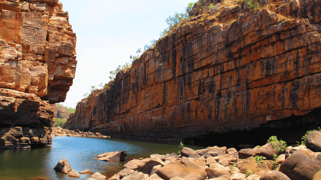 Rocky cliffs and calm waters of Katherine Gorge featured in 5-Day Top End 4WD Camping Safari. Iconic outdoor destination in Australia.