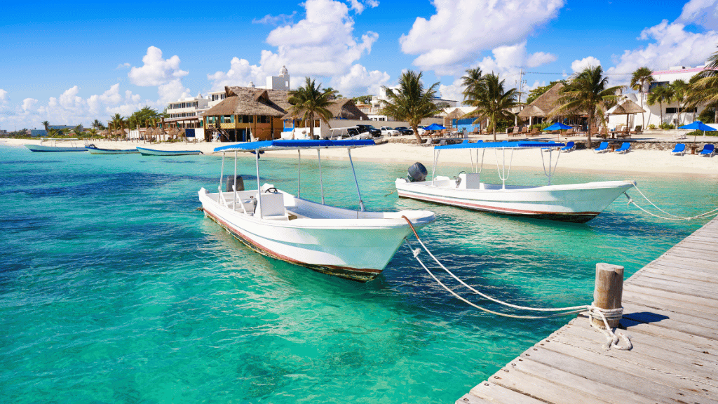 Docked boats on turquoise waters in Caye Caulker, part of the Belize City to Caye Caulker - Jungle to Reef Journey experience.