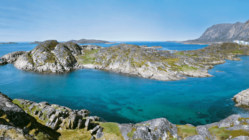 Rocky coastal landscape with turquoise waters in Greenland, part of the Atlantic Expedition Cruise - Iceland, Greenland, Labrador itinerary.