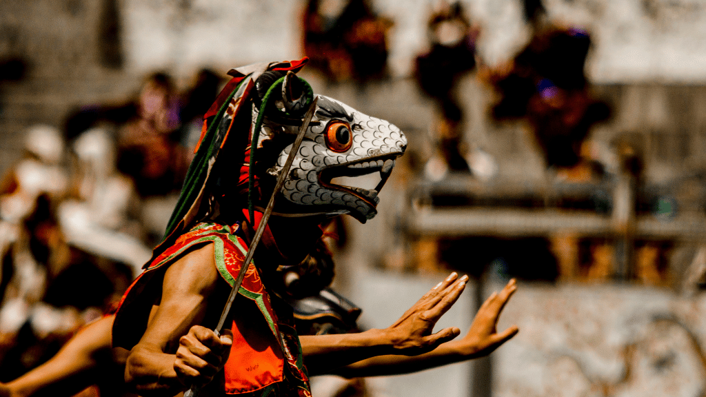 Masked dancer performing during a traditional festival, part of the cultural immersion on the Trans Bhutan Trail.