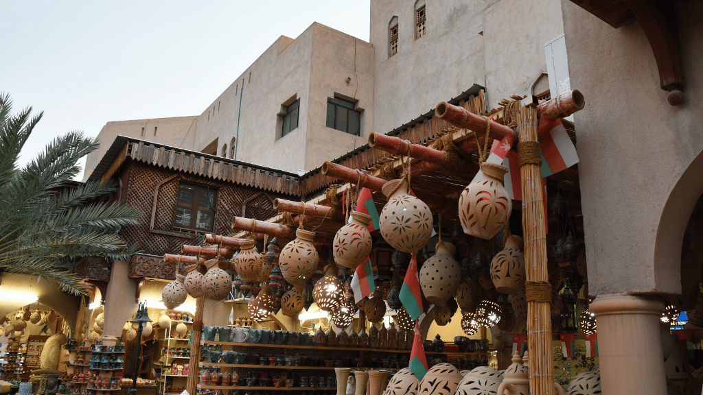 Traditional Omani pottery and souvenirs in a Muscat souq, part of the cultural immersion on the Oman 8 Day Adventure - Desert Stars & Turtle Shores tour.