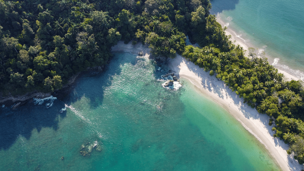Aerial view of a tropical beach cove in Costa Rica with turquoise waters and lush jungle, part of Costa Rica Adventure: Volcanoes, Coasts - Travel Tour.