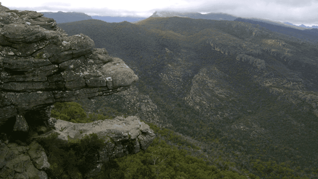 Rocky outcrop overlooking misty mountain ranges in the Southern Grampians, featured in the 5-Day Grampians Expedition trek.