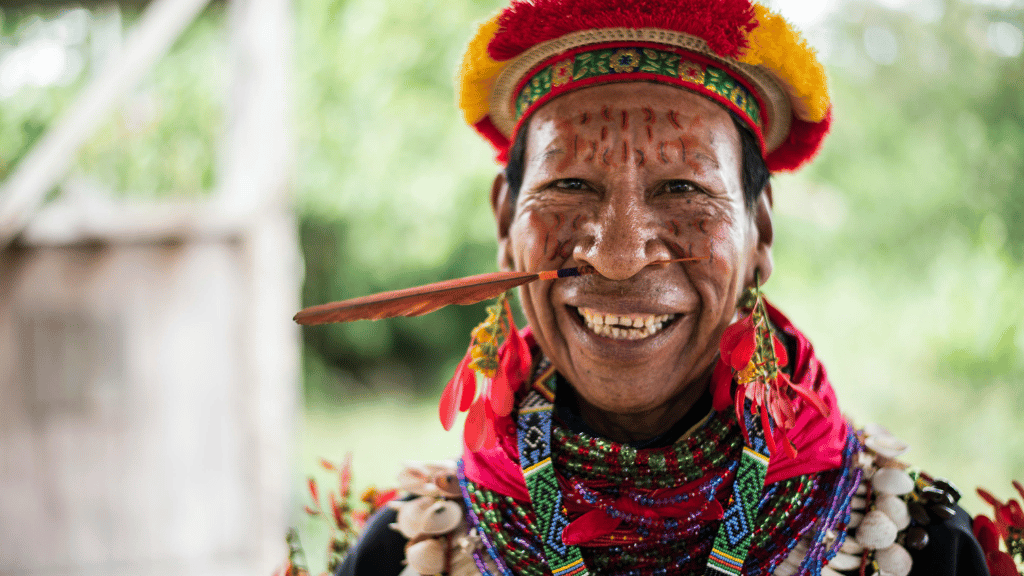 Quichua elder in traditional attire smiling during Amazon Homestay Adventure - Canoes, Cacao & More | Quichua Living cultural experience.