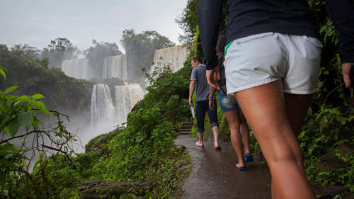 Travelers hiking near Iguazú Falls on a Quito to Rio journey. A highlight of South America tour packages from 15 to 65 days.