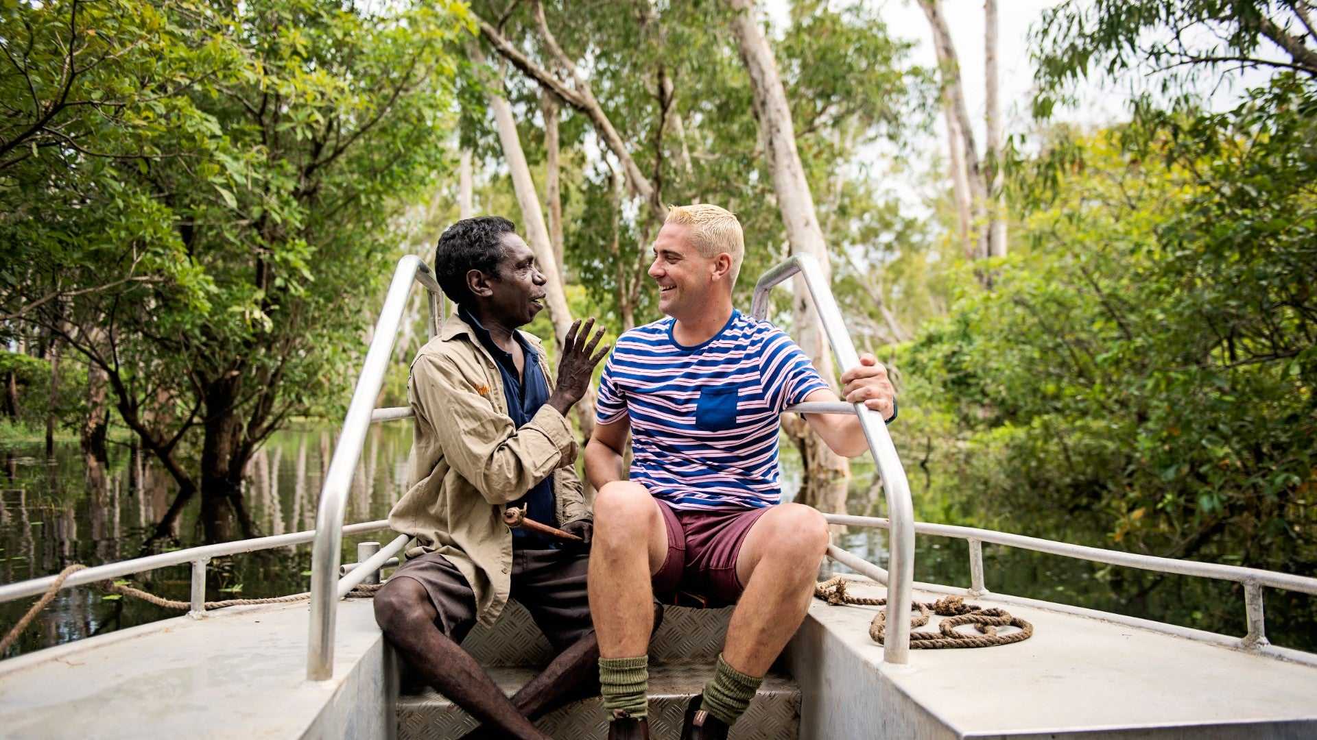 Local guide and tourist enjoy boat cruise through wetlands on Kakadu Katherine Gorge Tour | 4-Day Comfort Travel. Authentic cultural exchange.