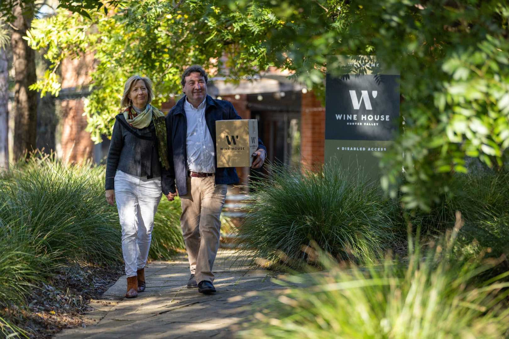 Couple walking at Wine House in Hunter Valley on East Coast Adventure 14/16-Day Small-Group Tour. Wine and leisure experience.