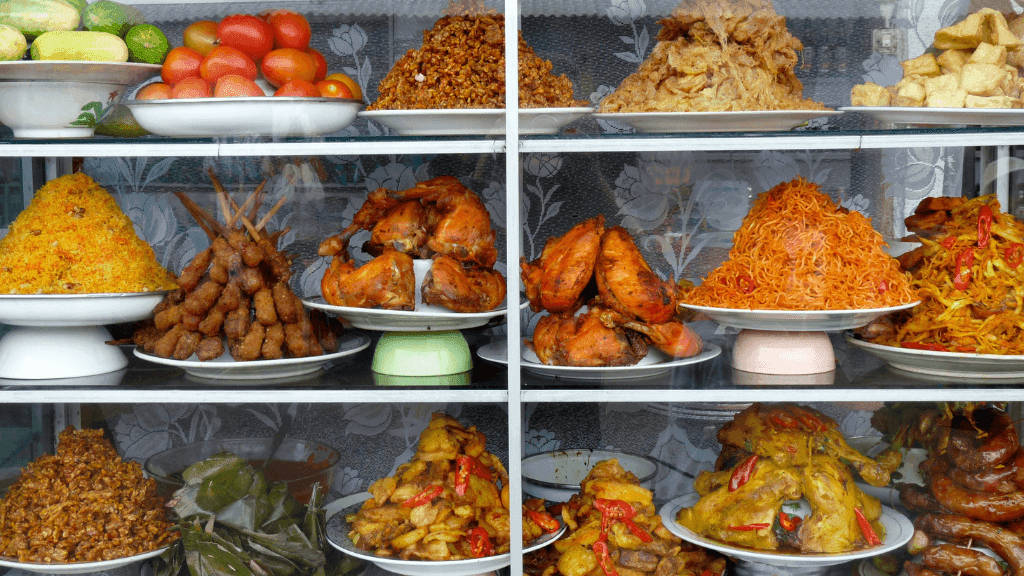 Display of Indonesian street food including noodles and grilled meats, featured in Bali Komodo Lombok Tours - Explore Culture & Nature.