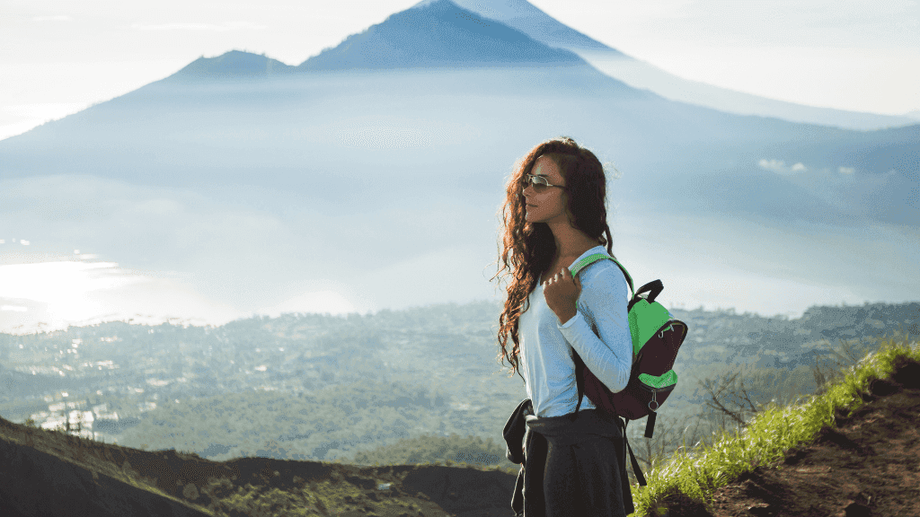 Female hiker overlooking Bali’s volcanic landscape, part of the adventure in Bali Komodo Lombok Tours - Explore Culture & Nature.