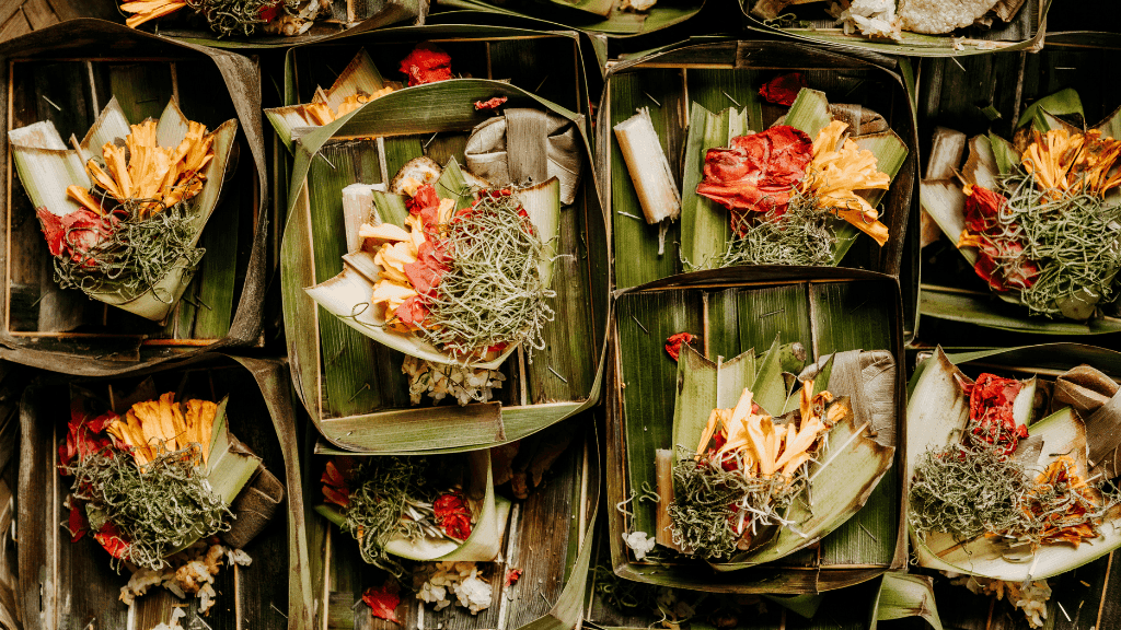 Traditional Balinese offerings made with flowers and leaves, part of spiritual culture in Bali Komodo Lombok Tours - Explore Culture & Nature.