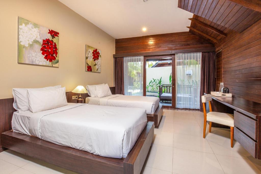 Modern twin-bed hotel room with pool access, part of the accommodations in Bali Komodo Lombok Tours - Explore Culture & Nature.