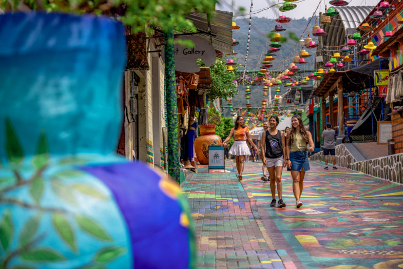 Travelers walking through a colorful street in Central America, featured in the Central America Itinerary - Mexico to Panama | Travel Highlights.
