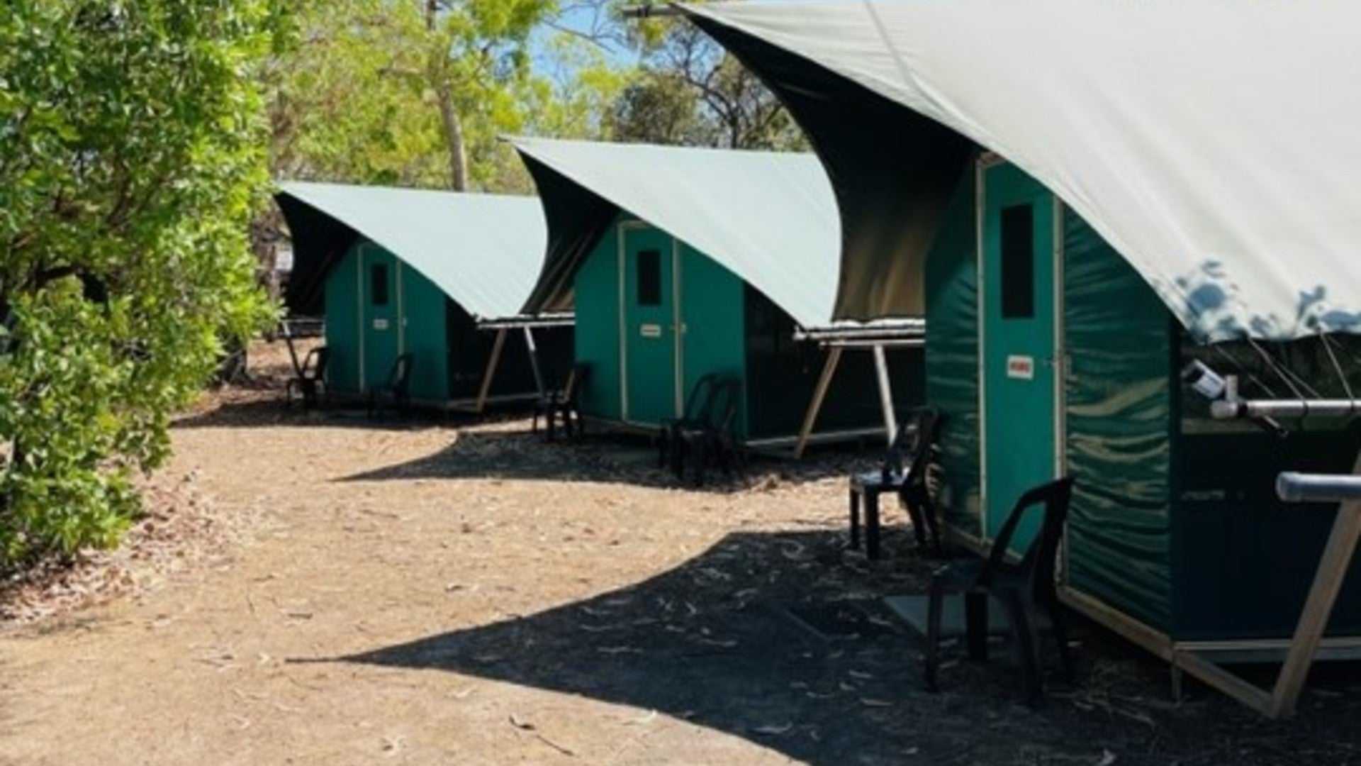 Canvas tents at campsite during Kakadu Litchfield Camping Adventure - 3-Day Tour. Comfortable outdoor accommodation in shaded area.