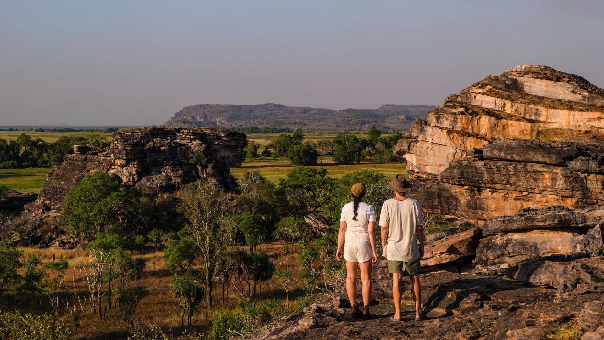 Couple admires panoramic view of Kakadu escarpment on Kakadu Katherine Gorge Tour | 4-Day Comfort Travel. Iconic Australian landscape.