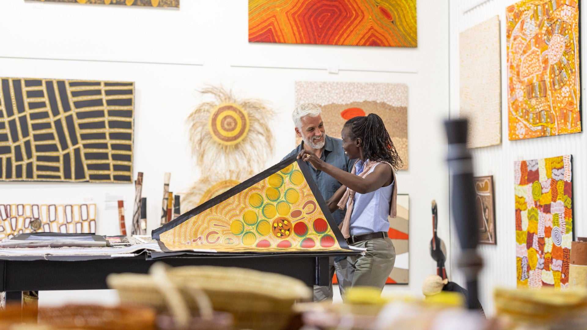 Visitors explore Aboriginal art gallery on Kakadu Katherine Gorge Tour | 4-Day Comfort Travel. Indigenous artwork and cultural learning.