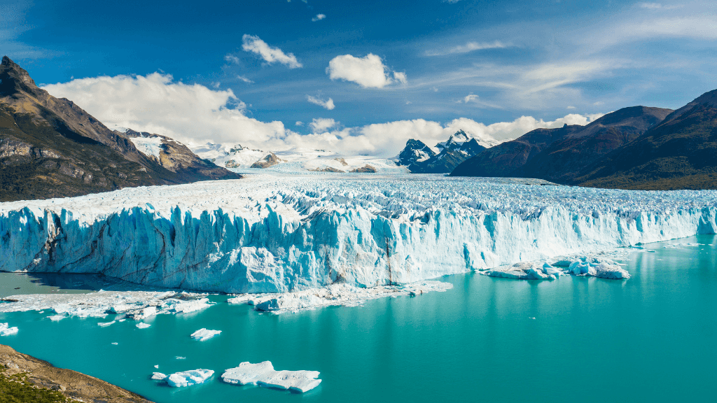 Expansive glacier meeting turquoise lake in Patagonia, featured in the 9-day Blue Heart Adventure hiking tour through Torres del Paine and Argentina.