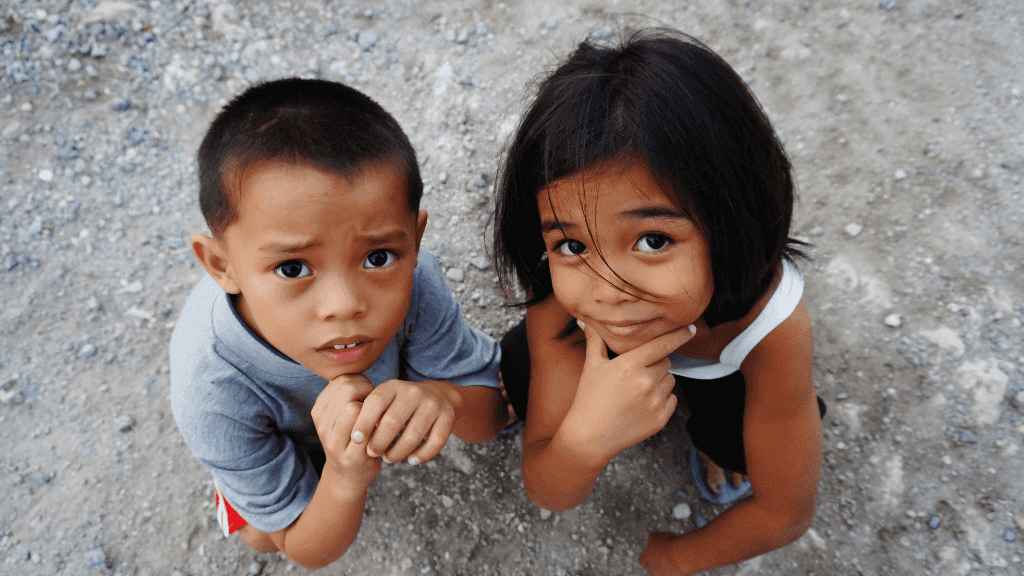 Two Filipino children looking up curiously, cultural connection in Philippines Travel Tours - Icons of the Philippines | 10/14/23 Days.