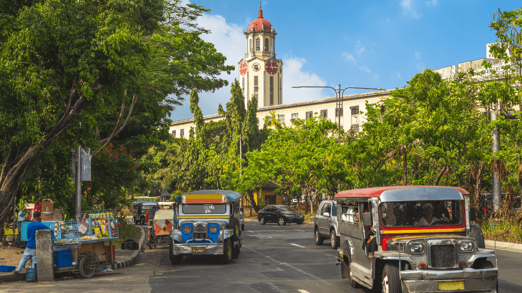 Colorful jeepneys on a Manila street, local transport experience in Philippines Travel Tours - Icons of the Philippines | 10/14/23 Days.