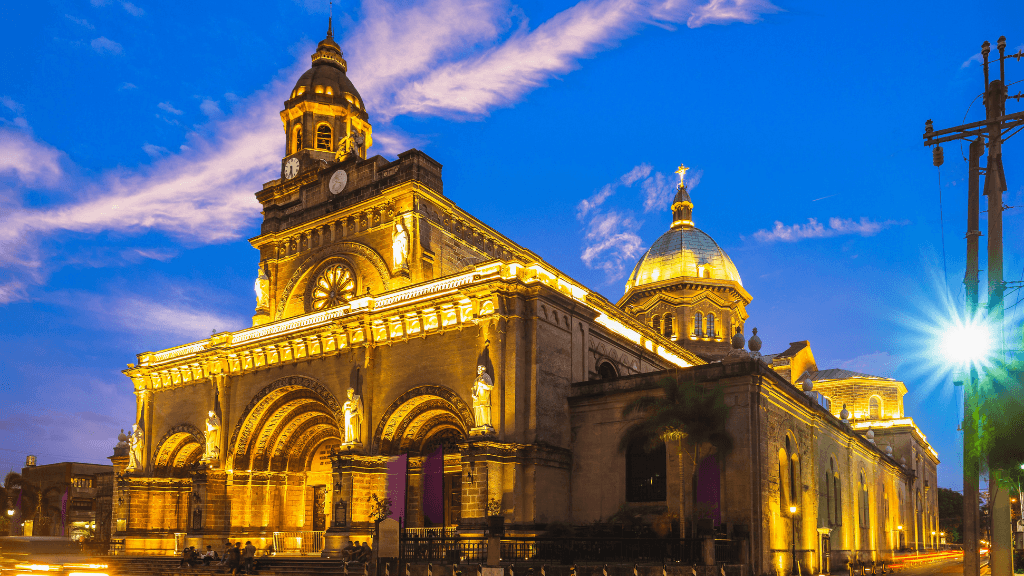 Manila Cathedral illuminated at night, historical landmark in Philippines Travel Tours - Icons of the Philippines | 10/14/23 Days.