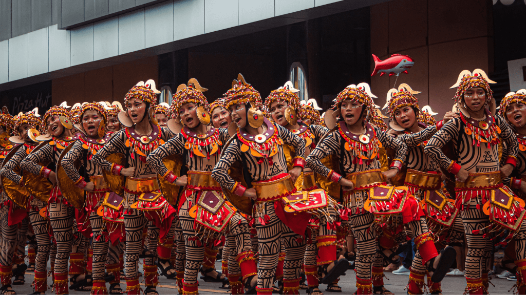 Colorful street dancers in tribal costumes during a Philippine festival, included in Philippines Travel Tours - Icons of the Philippines.