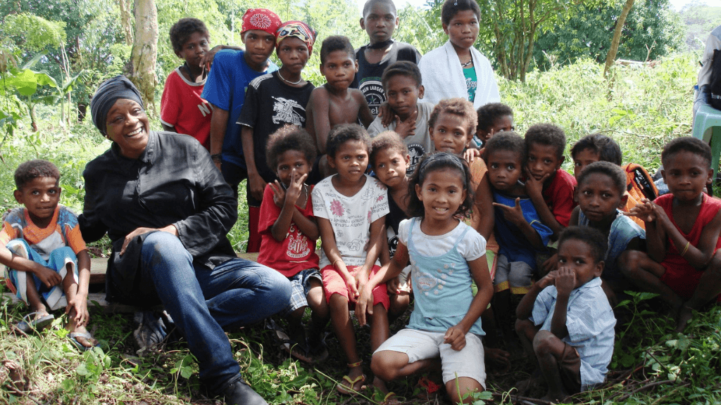 Group of local children and a visitor in a rural Philippine village, cultural immersion in Philippines Travel Tours - Icons of the Philippines.