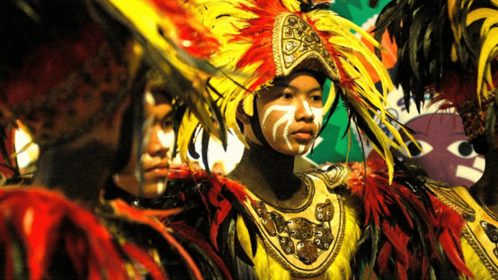 Young performers in feathered tribal attire, showcasing culture in Philippines Travel Tours - Icons of the Philippines | 10/14/23 Days.