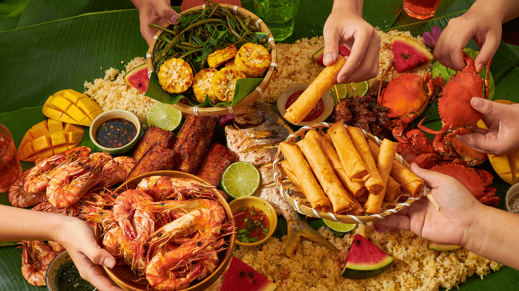 Seafood boodle fight with prawns, crabs, and tropical fruits, part of culinary experiences in Philippines Travel Tours - Icons of the Philippines.