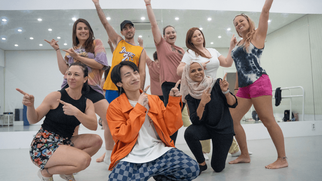 Travelers enjoy a K-pop dance class in Seoul, part of the South Korea cultural tour blending modern entertainment with traditional experiences.
