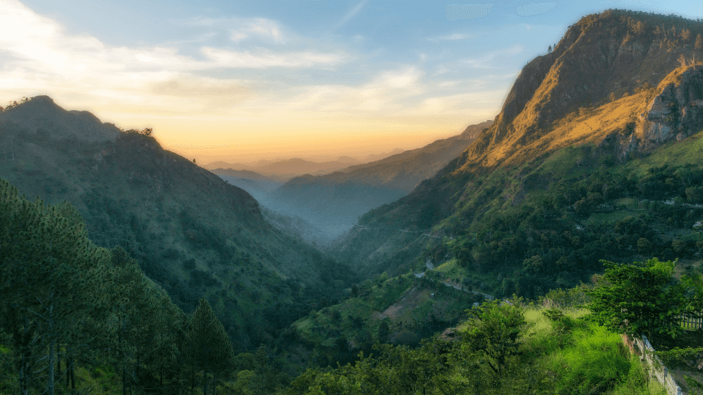 Sunset view over Sri Lanka's emerald hills, a scenic highlight of the 12-day spice gardens and tropical coasts travel experience.