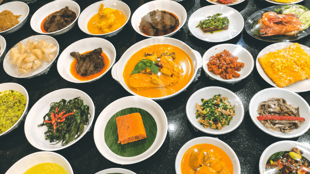 Traditional Sumatran dishes served in multiple bowls, showcasing local cuisine on the Wild Orangutan 8-Day Loop adventure.