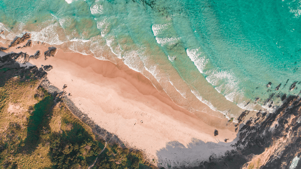Aerial view of secluded beach on East Coast Australia tour. Coastal beauty on 8-day journey from Sydney to Brisbane.