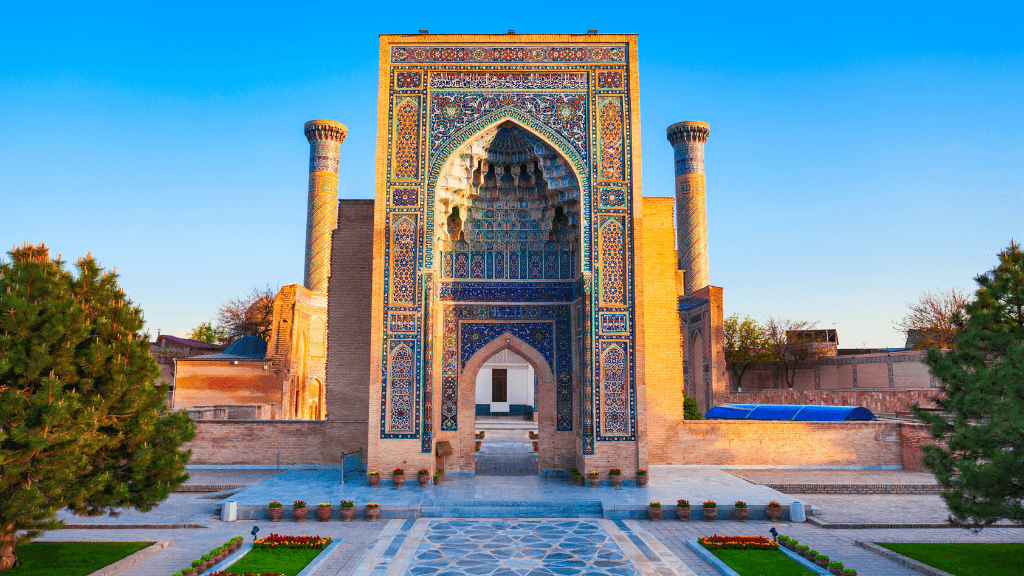 Majestic entrance of a tiled madrasa in Samarkand, part of the Silk Road Cities Tour - Central Asia Adventure. Features intricate Islamic architecture.