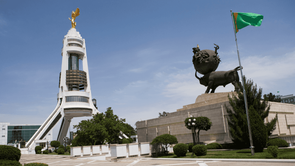 Modern monument and lion statue in Ashgabat, Turkmenistan, featured in the Silk Road Cities Tour - Central Asia Adventure itinerary.