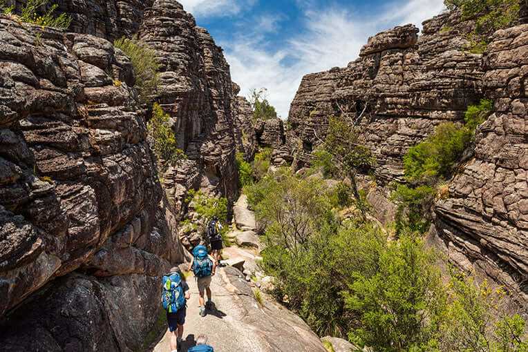 Hikers exploring the stunning rock formations of the Central Grampians during an adventurous group trek.