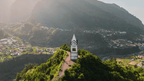 White clock tower on a hilltop in Madeira surrounded by mountains, a scenic viewpoint on the 6-days hiking Madeira’s trails.