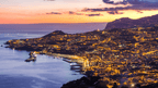Funchal city lights at sunset viewed from above, a scenic stop during the 6-days hiking Madeira’s trails adventure.