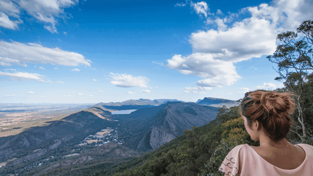 Stunning panoramic view from Gariwerd, showcasing rugged mountains and lush valleys on a guided adventure.