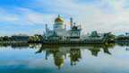 Golden-domed mosque reflecting on water in Borneo, a cultural highlight of the 7-day orangutan and wildlife viewing tour.