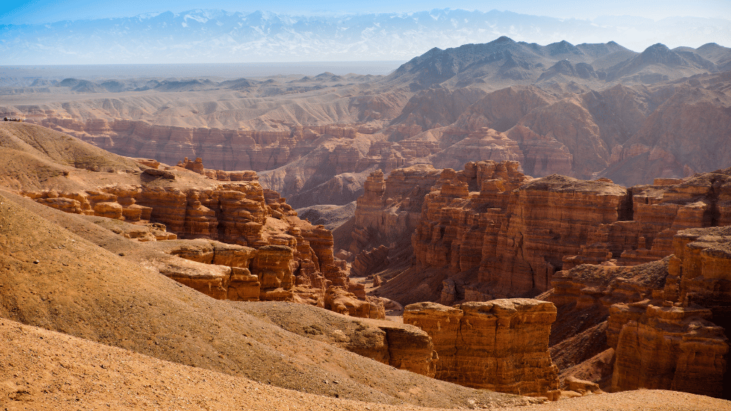 Expansive view of Charyn Canyon’s layered cliffs in Kazakhstan, a geological marvel on the 14-23 Day Central Asia Silk Road Tour.