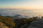 Stunning mountain vista over fog-covered valleys at sunrise, perfect for outdoor adventure and travel enthusiasts.