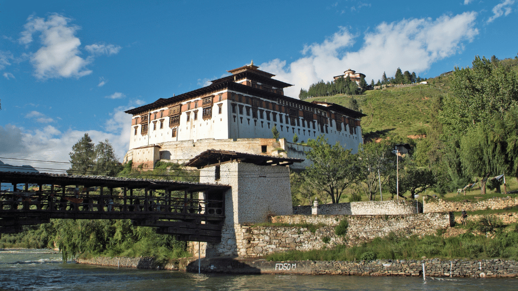 Historic dzong by a river on the Trans Bhutan Trail, one of many cultural landmarks visited during the adventure.