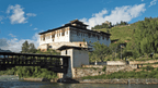 Historic dzong by a river on the Trans Bhutan Trail, one of many cultural landmarks visited during the adventure.