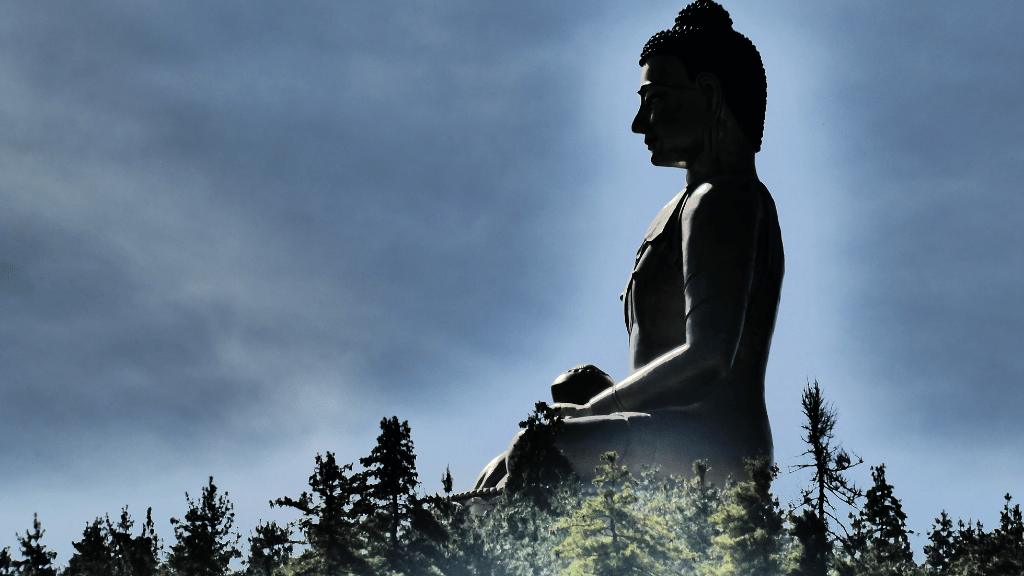 Giant Buddha Dordenma statue overlooking forested hills, a spiritual site on the Trans Bhutan Trail adventure.
