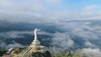Massive Jesus Buntu Burake statue overlooking misty highlands, a scenic stop on the Soul of Sulawesi - Tana Toraja Culture Tour.
