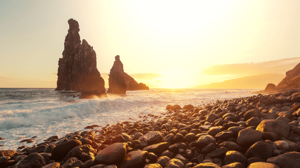 Rocky beach at sunset with sea stacks in Madeira, a serene moment during the 6-days hiking Madeira’s trails experience.