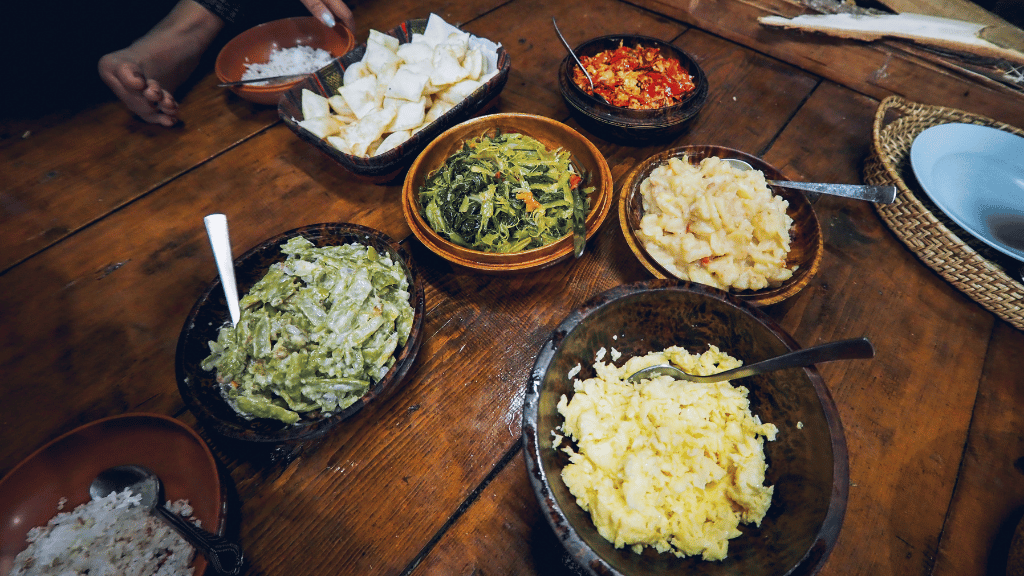 Traditional Bhutanese farm lunch with local dishes, part of the culinary experiences on the Trans Bhutan Trail tour.