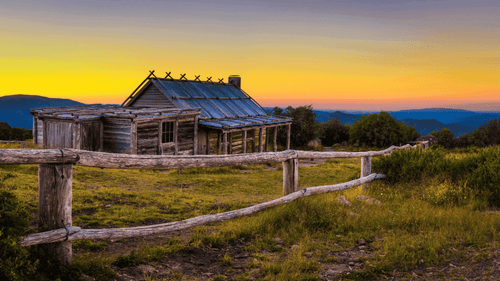 Rustic cabin at sunset in Victoria's High Country, perfect for adventure tours and outdoor travel.