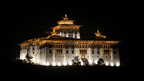 Illuminated dzong at night along the Trans Bhutan Trail, showcasing Bhutanese architecture during hotel stays.